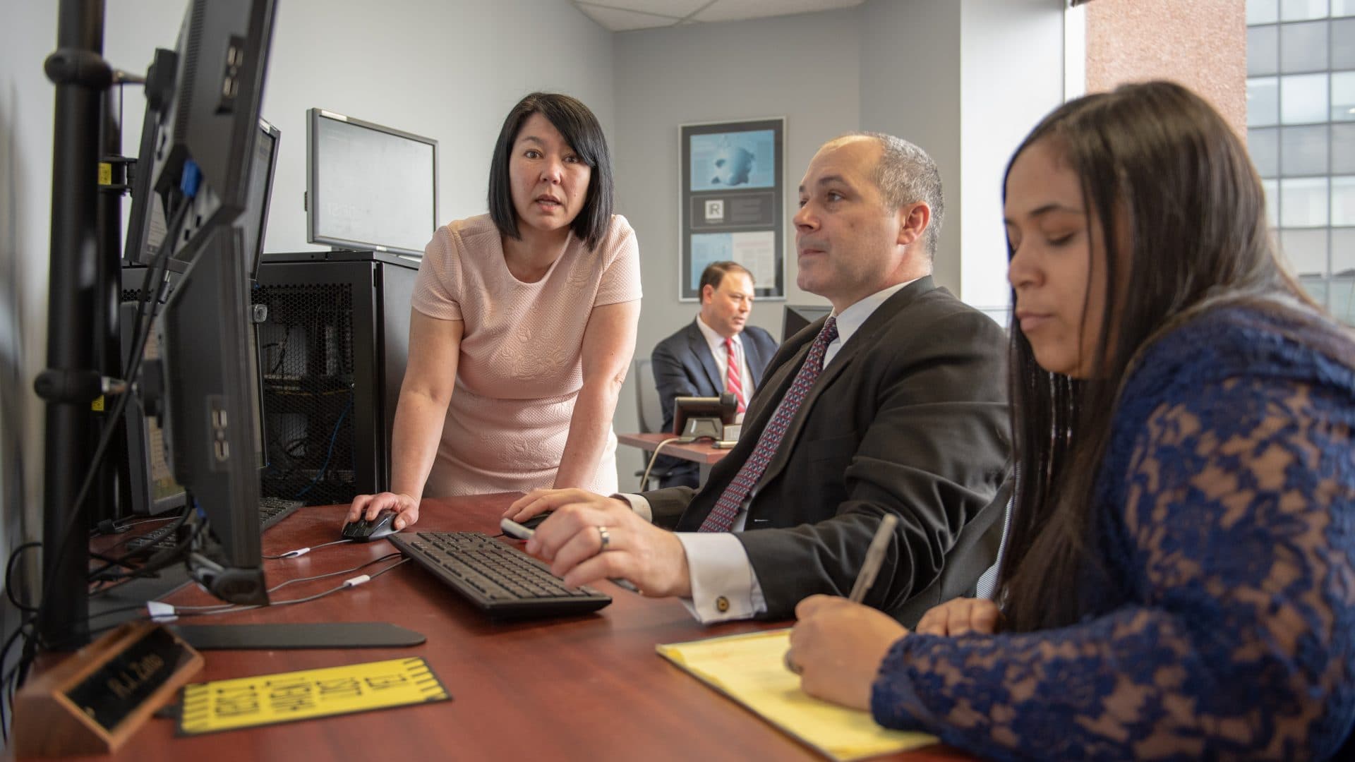 Colleagues discussing market information in a modern office